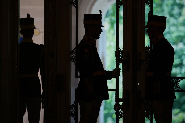 Honor guards stand by the doors before the opening session of the Bucharest B9 summit at the Cotroceni Presidential Palace in Bucharest, Romania, Wednesday, May 13, 2026. (AP Photo/Vadim Ghirda)