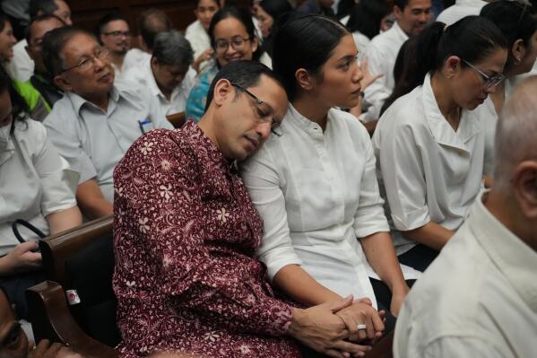 Nadiem Anwar Makarim, the co-founder of Indonesia's payments platform and ride hailing company Gojek and former education minister, sits next to his wife Franka Franklin Makarim before the start of his trial hearing at the Corruption Court in Jakarta, Indonesia, Wednesday, May 13, 2026. (AP Photo/Tatan Syuflana)
