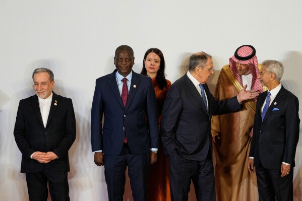 Russia's Foreign Minister Sergey Lavrov, third right, talks to Vice Minister of Foreign Affairs of Saudi Arabia, Waleed bin Abdulkarim, second right, as Indian Foreign Minister S.Jaishankar, right, South Africa's Minister of Foreign Affairs Ronald Lamola, second left, Iranian Foreign Minister Abbas Araghchi, left, and and Vietnam Deputy Foreign Minister Nguyen Hang, third left, watch at a photo call of Government representatives and partner countries of BRICS during a two day meeting in New Delhi, India, Thursday, May 14, 2026. (AP Photo/Manish Swarup)