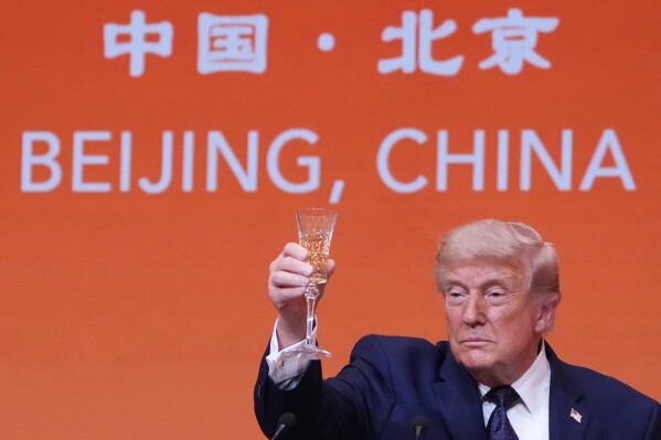 President Donald Trump proposes a toast during a state dinner with China's President Xi Jinping at the Great Hall of the People on Thursday May 14, 2026, in Beijing. (AP Photo/Mark Schiefelbein)