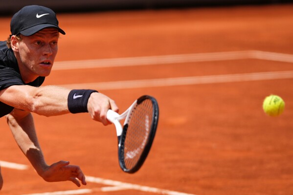 Italy's Jannik Sinner returns the ball to Andrey Rublev, during their match at the Italian Open tennis tournament in Rome, Thursday, May 14, 2026. (AP Photo/Andrew Medichini)