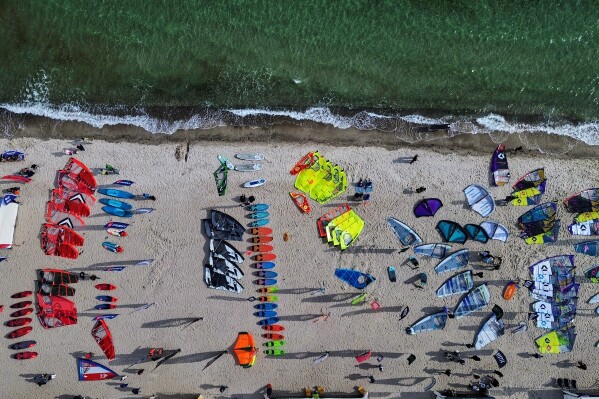 Sails are displayed during a surf festival at the Baltic Sea in Burg on the island of Fehmarn, Germany, Thursday, May 14, 2026. (AP Photo/Michael Probst)