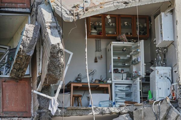Apartment interiors are seen in a damaged residential house following Russian missile attack in Kyiv, Ukraine, Thursday, May 14, 2026. (AP Photo/Efrem Lukatsky)
