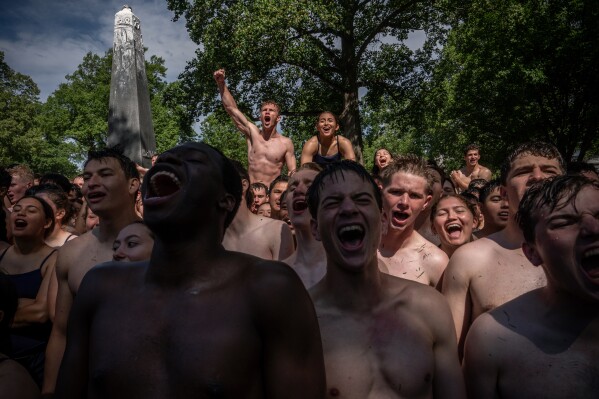First-year midshipmen celebrate after completing the Herndon Monument Climb to cap off their plebe year at the U.S. Naval Academy, Wednesday, May 13, 2026, in Annapolis, Md. (AP Photo/Julia Demaree Nikhinson)