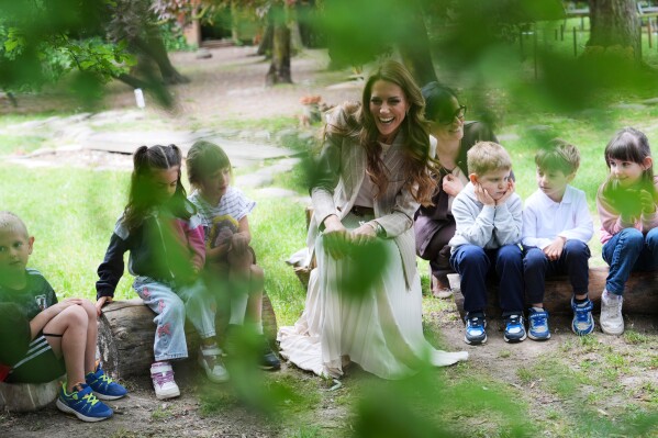 Britain's Kate, Princess of Wales sits with children during her visits the Salvador Allende preschool to observe how nature-based learning is embedded within the Reggio Emilia approach, part of a two-day trip, in Reggio Emilia, Italy, Thursday, May 14, 2026. (AP Photo/Antonio Calanni, Pool)