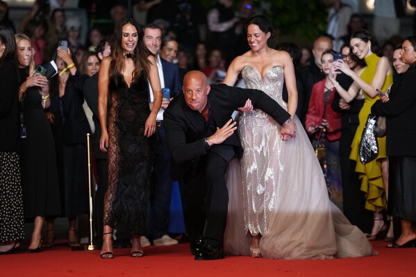 Jordana Brewster, from left, Vin Diesel and Michelle Rodriguez pose for photographers upon arrival for the 25th anniversary of the film 'The Fast and the Furious' at the 79th international film festival, Cannes, southern France, Thursday, May 14, 2026. (Photo by Scott A Garfitt/Invision/AP)