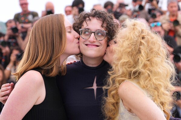 Hannah Einbinder, from left, director Jane Schoenbrun and Gillian Anderson pose for photographers at the photo call for the film 'Teenage Sex and Death at Camp Miasma' during the 79th international film festival, Cannes, southern France, Wednesday, May 13, 2026. (AP Photo/Andreea Alexandru)