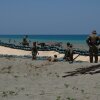 Soldiers of the U.S. Army's 25th Infantry Division build fighting positions with sandbags along the beach of the La Paz sand dunes in Laoag City, Philippines.