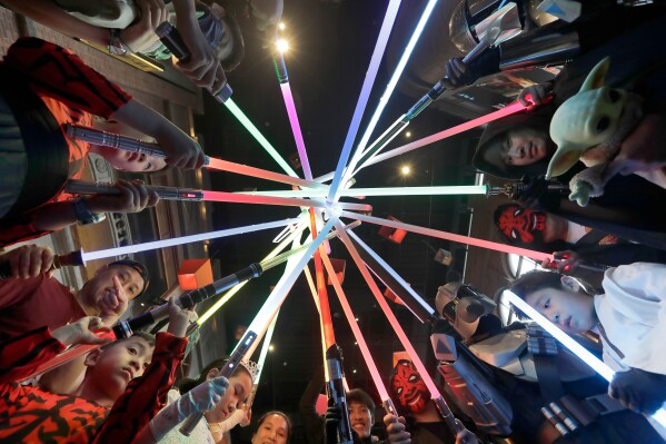 Fans dressed as characters of the movie ''Star Wars'' pose for photo in a Star Wars event at a department store in Taipei, Taiwan, Saturday, May 16, 2026. (AP Photo/Chiang Ying-ying)