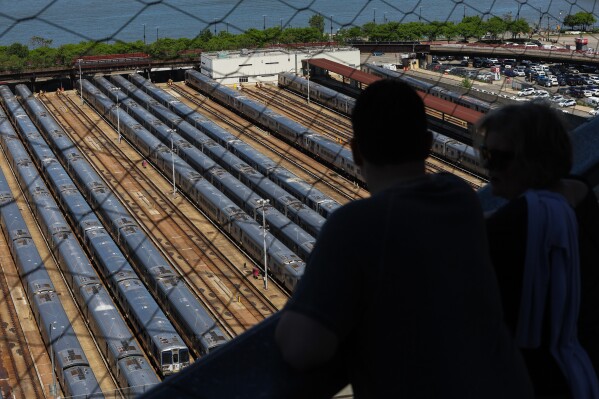 Visitors look out at the trains at the West Side Yard from the Vessel on the first day of a Long Island Rail Road workers' strike, Saturday, May 16, 2026, in New York. (AP Photo/Heather Khalifa)