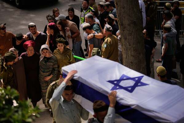 Israeli soldiers carry the flag-draped casket of Capt. Maoz Israel Recanati who was killed in a Lebanese drone attack in southern Lebanon, during his funeral in Mt. Herzl military cemetery in Jerusalem, Sunday, May 17, 2026. (AP Photo/Ohad Zwigenberg)