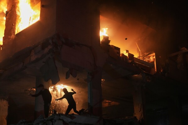 Palestinians react to a fire following an Israeli strike on a residential building in the Rimal neighborhood of Gaza City, Friday, May 15, 2026. (AP Photo/Jehad Alshrafi)