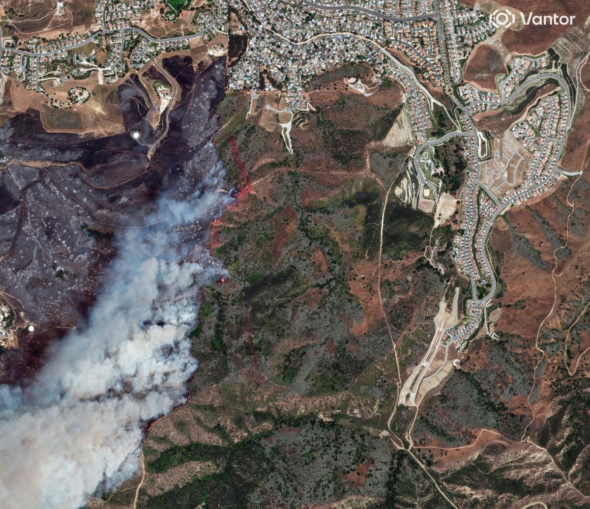 A satellite image showing terrain and smoke
