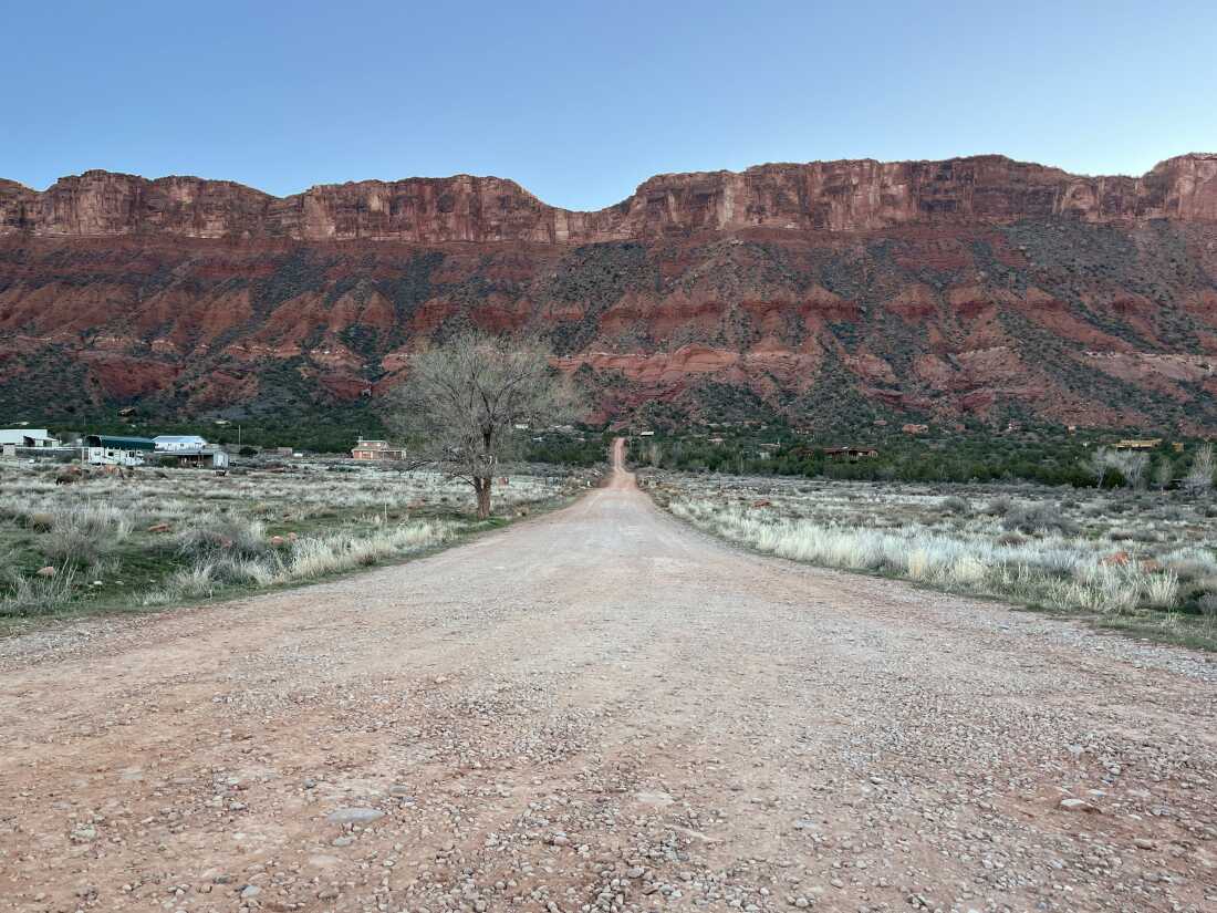 A gravel road leads to a group of homes in Castle Valley, Utah. 