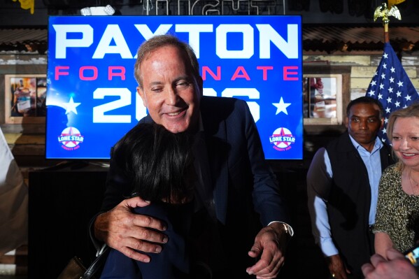 Texas Attorney General Ken Paxton, a Republican candidate for the U.S. Senate, hugs Terry Wade at a campaign event in McKinney, Texas, Tuesday, May 19, 2026. (AP Photo/LM Otero)