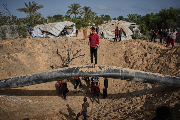 Palestinians inspect the destruction caused by an Israeli strike in Khan Younis, southern Gaza Strip, Tuesday, May 19, 2026. (AP Photo/Abdel Kareem Hana)