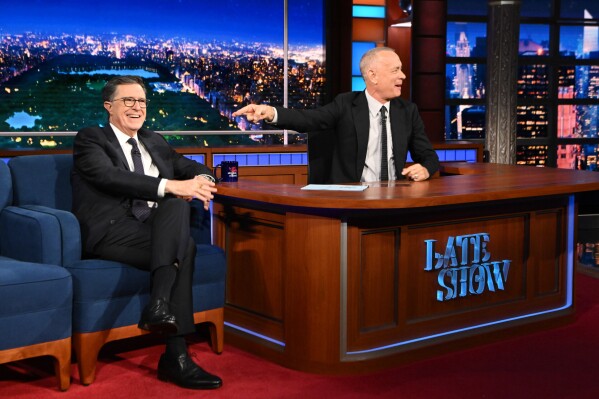 This image released by CBS shows host Stephen Colbert, left, with guest Tom Hanks on "The Late Show with Stephen Colbert" in New York on May 13, 2026. (Scott Kowalchyk/CBS via AP)