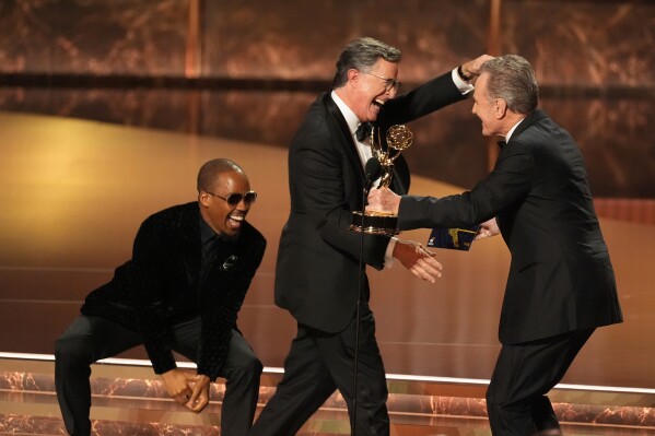 Bryan Cranston, right, presents the award for outstanding talk series to Stephen Colbert, left, for "The Late Show with Stephen Colbert" during the 77th Primetime Emmy Awards in Los Angeles on Sept. 14, 2025. (AP Photo/Chris Pizzello, File)