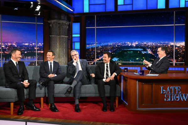 This image released by CBS shows host Stephen Colbert, right, with guests, from left, Jimmy Kimmel, Jimmy Fallon, John Oliver, and Seth Meyers on "The Late Show with Stephen Colbert" in New York on May 11, 2026. (Scott Kowalchyk/CBS via AP)