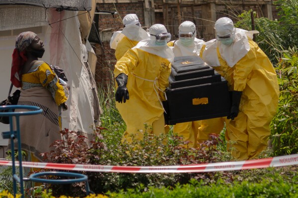 A woman cries as Red Cross workers carry the coffin of a person who died of Ebola from a health center in Rwampara, Congo, Wednesday, May 20, 2026. (AP Photo/Moses Sawasawa)