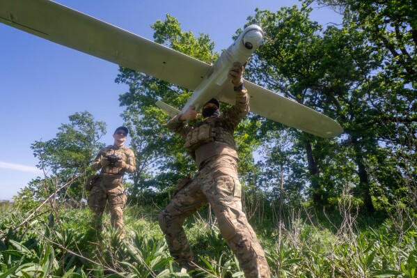 Ukrainian servicemen of Khartia brigade launch a drone towards Russian positions at the front line in the Kharkiv region, Ukraine, Wednesday, May 20, 2026. (AP Photo/Andrii Marienko)