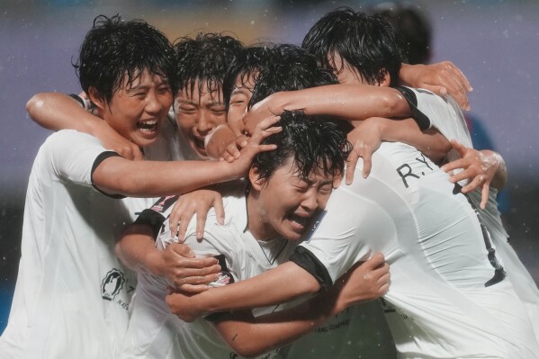 North Korea's Naegohyang Women's FC, Kim Kyong Yong, centre, is congratulated by teammates after scoring her team's second goal during the AFC Women's Champions League semifinal match against South Korea's Suwon FC in Suwon, South Korea, Wednesday, May 20, 2026. (AP Photo/Lee Jin-man)