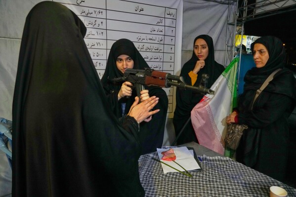 A woman handles a Kalashnikov-style assault rifle during a weapons training class in Tehran, Iran, Tuesday, May 19, 2026. (AP Photo/Vahid Salemi)