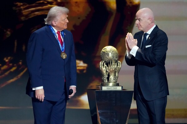 FIFA President Gianni Infantino, right, awards President Donald Trump with the FIFA Peace Prize during the draw for the 2026 soccer World Cup at the Kennedy Center in Washington, Friday, Dec. 5, 2025. (AP Photo/Chris Carlson, file)