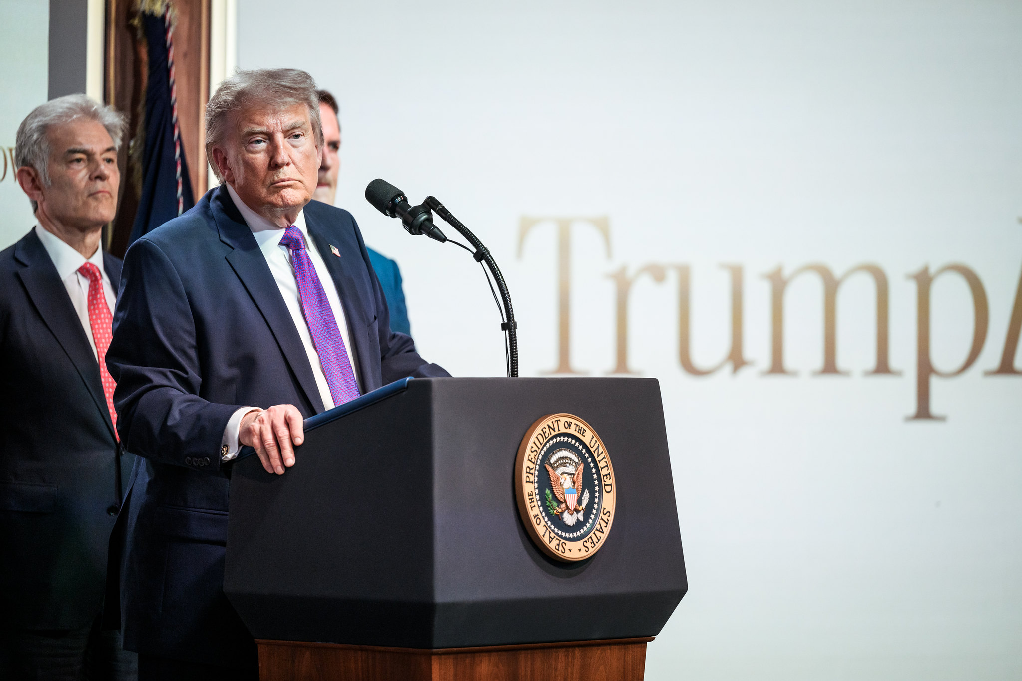 President Trump is shown at a podium.