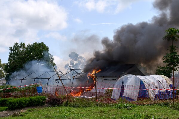 Flames and smoke rise from an Ebola treatment center in Rwampara, Congo, Thursday, May 21, 2026. (AP Photo/Dirole Lotsima Dieudonne)