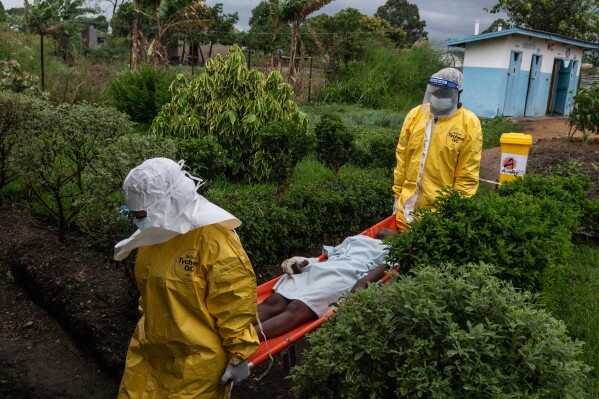 Medical staff carry an Ebola patient to a treatment center in Rwampara, Congo, Thursday, May 21, 2026. (AP Photo/Moses Sawasawa)