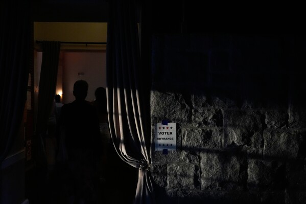 A sign directs voters arriving to vote on Tuesday, May 19, 2026, in Atlanta. (AP Photo/Brynn Anderson)