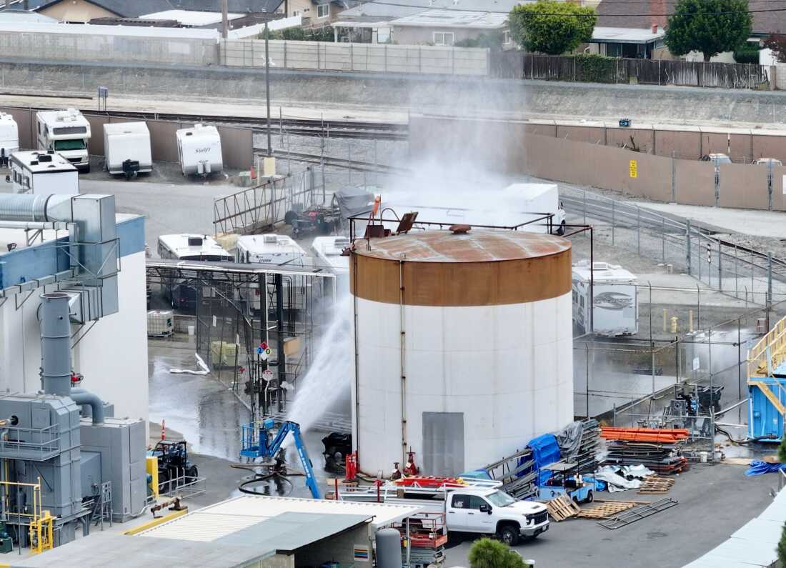 Water is sprayed on a tank that overheated at an aerospace plant in Garden Grove, Calif., on Friday.