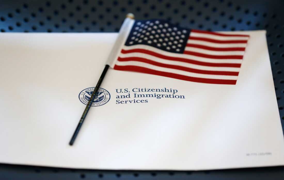 An information packet and an American flag are placed on a chair at the U.S. Citizenship and Immigration Services Miami Field Office on Aug. 17, 2018, in Miami.