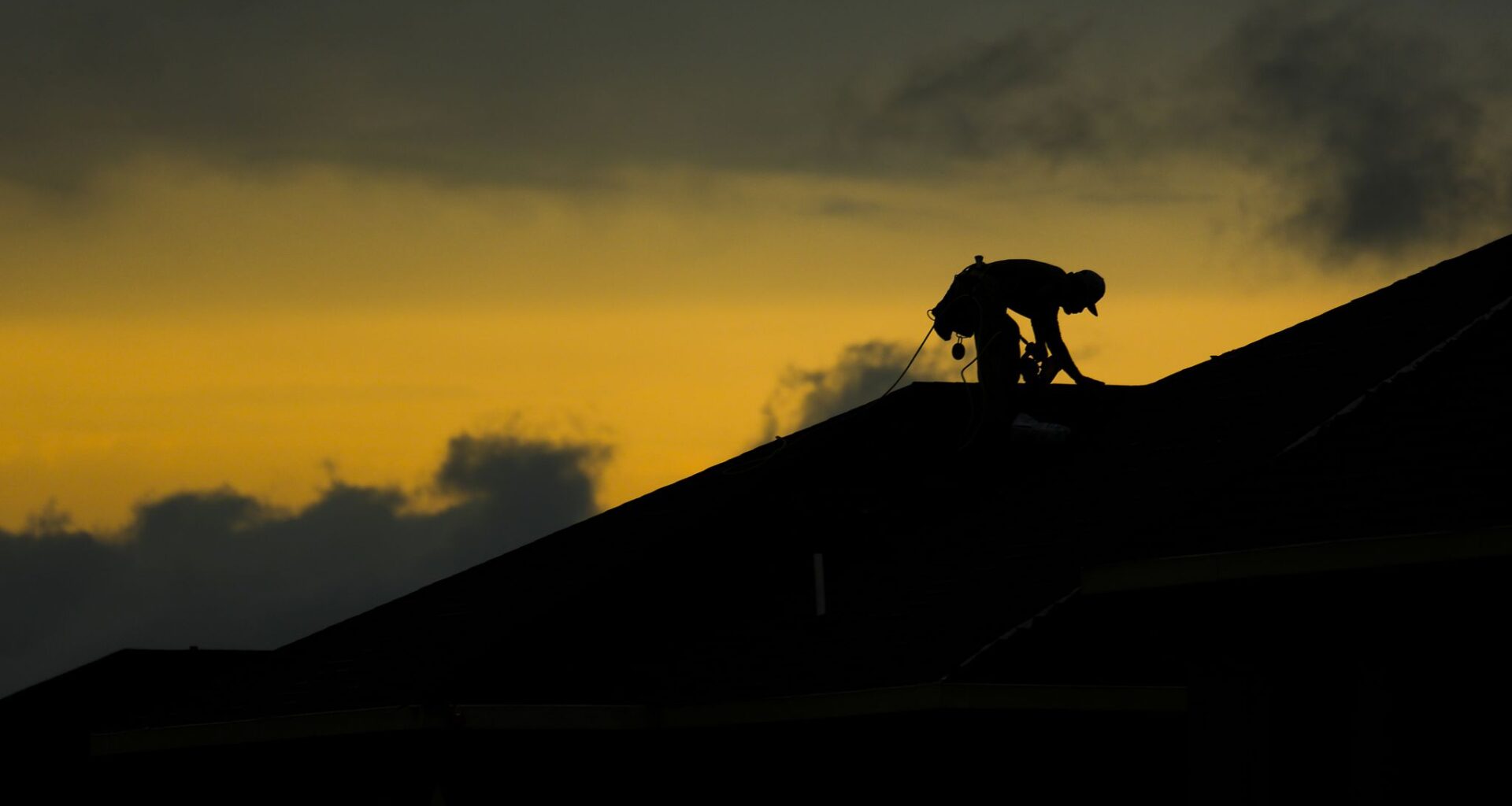 A roofer works on a home under construction as storm clouds begin to break to the west after a thunderstorm in Frisco, Tuesday, May 19, 2026.