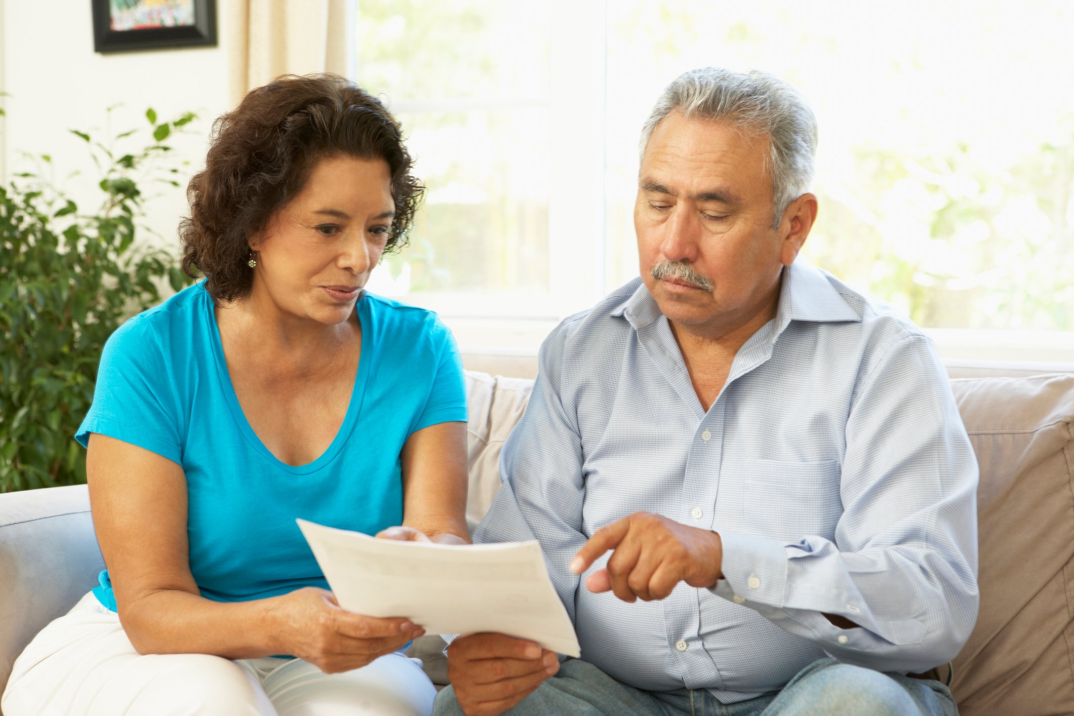 Couple discussing a document together.