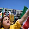 A banner of President Donald Trump hangs over Iranian Americans and their supporters as they march from the U.S. Capitol to the World War II Memorial during a rally Saturday, May 16, 2026, in Washington.