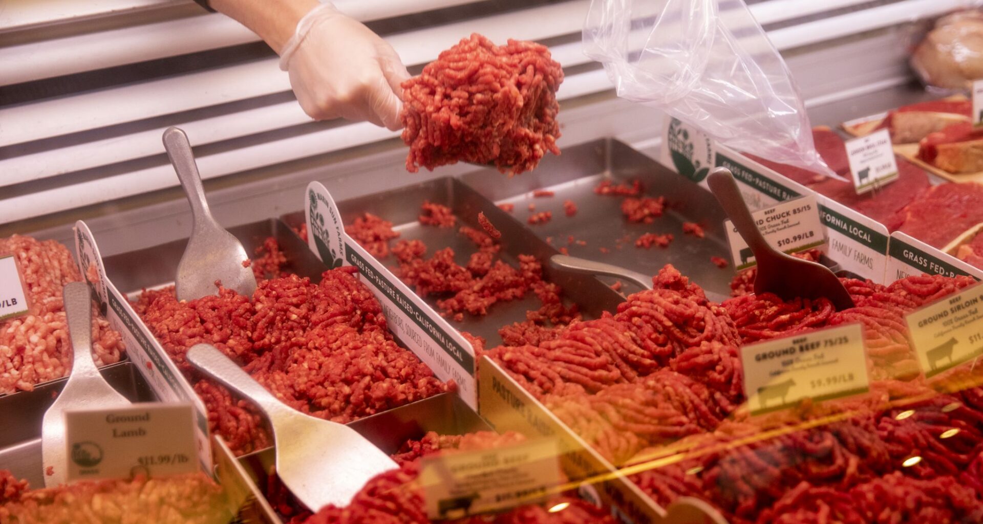An employee prepares an order of ground beef for a customer at an Oakland butcher shop in 2020. Ground beef prices are up nearly 19% compared to this time last year.
