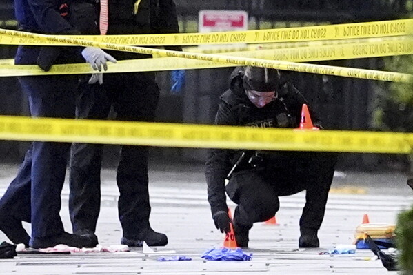 U.S. Secret Service Police place evidence markers on a crime scene after responding to reports of shots fired near the White House, Saturday, May 23, 2026, in Washington. (AP Photo/Alex Brandon)