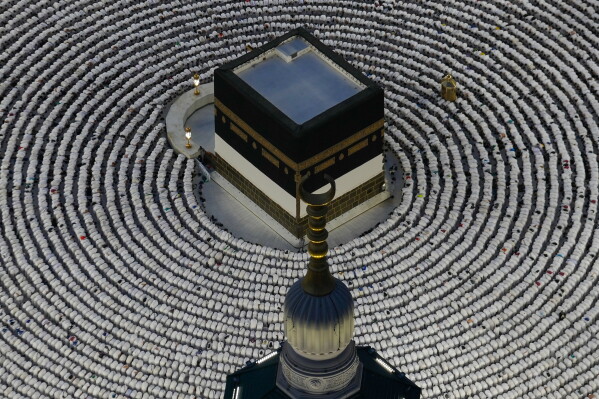 Muslim pilgrims prostrate as they offer evening prayers around the Kaaba, Islam's holiest site in the holy city of Mecca during the annual hajj pilgrimage, Saudi Arabia, Sunday, May 24, 2026. (AP Photo/Altaf Qadri)