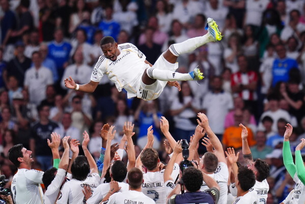 Real Madrid's players throw David Alaba after playing the last game for the club after a La Liga soccer match between Real Madrid and Athletic in Madrid, Spain, Saturday, May 23, 2026. (AP Photo/Manu Fernandez)