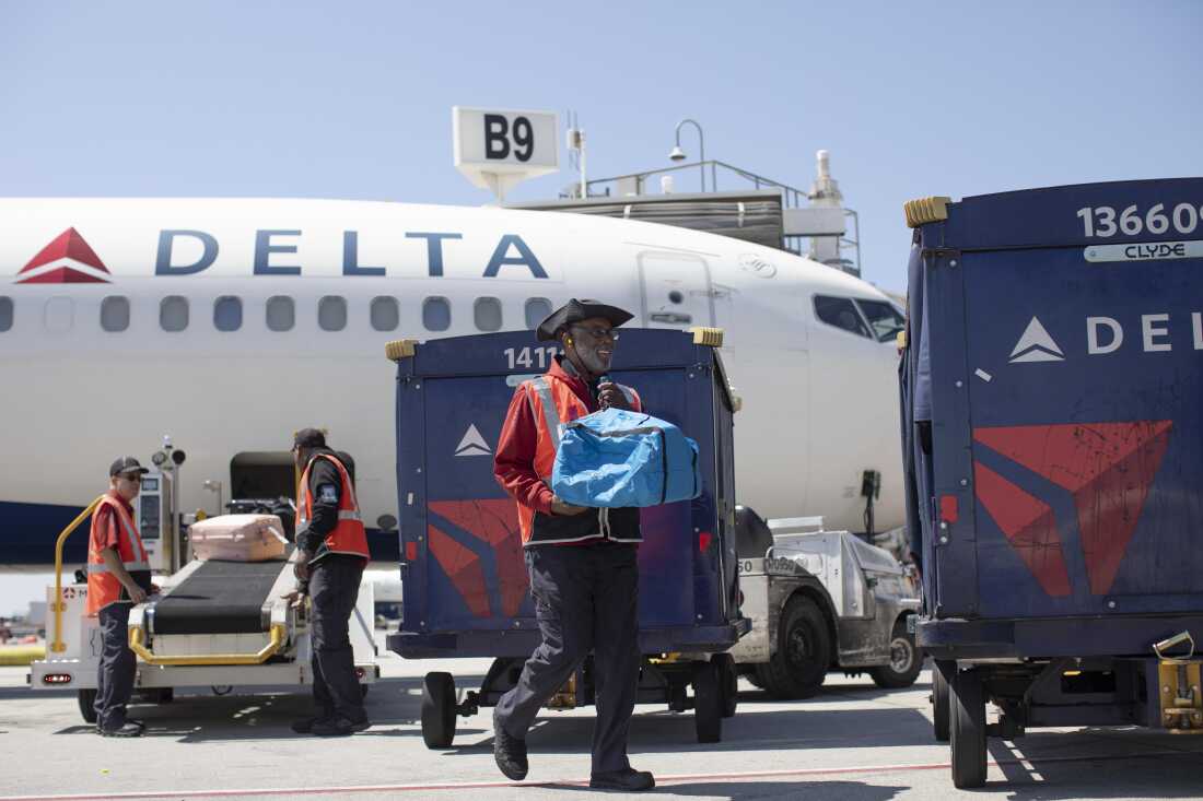 Delta Air Lines ramp agent Mike Davis prepares to load passenger luggage on his luggage cart while working on the tarmac at Atlanta Hartsfield Jackson International Airport in Atlanta, on May 13, 2026.