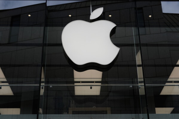 The Apple logo is illuminated at a store in Munich, Germany, April 2, 2026. (AP Photo/Matthias Schrader, File)