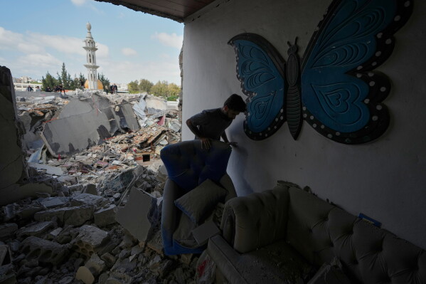 A man checks a house that was destroyed in an Israeli airstrike in Burj al-Shemali village near the southern port city of Tyre, Lebanon, Tuesday, May 26, 2026. (AP Photo/Mohammed Zaatari)