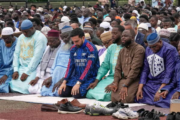 New York Mayor Zohran Mamdani, fourth from right, prays during an Eid al-Adha service, in the Bronx borough of New York, Wednesday, May 27, 2026. (AP Photo/Richard Drew)