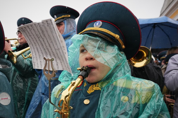 Young musicians performs in the rain during celebrations of the 323rd anniversary of St. Petersburg, in St. Petersburg, Russia, Wednesday, May 27, 2026. (AP Photo/Dmitri Lovetsky)