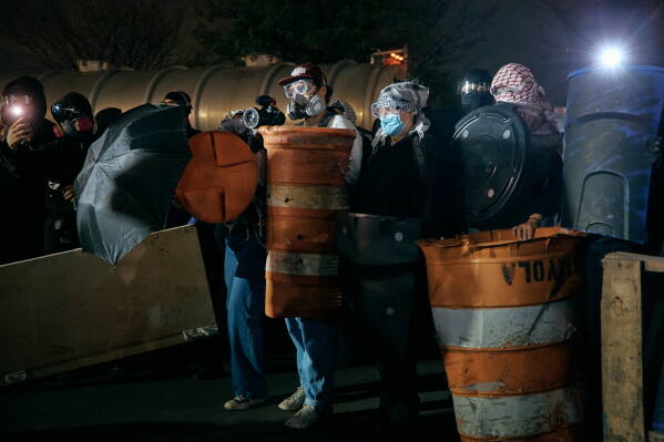 Protesters barricade the entrance gates outside the Delaney Hall detention on Wednesday, May 27, 2026, in Newark, N.J. Inside the facility, detainees carried out a labor and hunger strike for days over alleged living conditions. (AP Photo/Andres Kudacki)