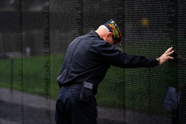 A veteran pays respects at the Vietnam Veterans Memorial, Monday, May 25, 2026, in Washington. (AP Photo/Allison Robbert)