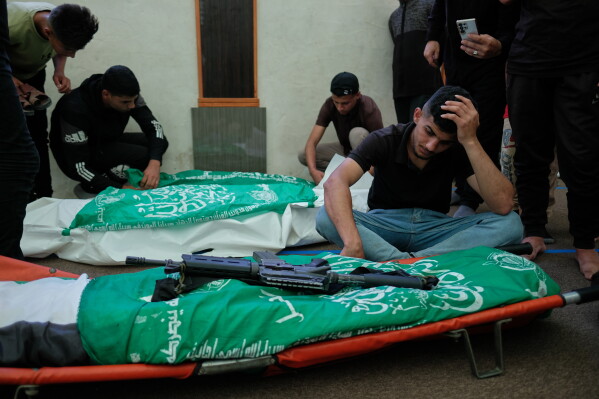Palestinians mourn over the bodies of Hamas militant Imad Isleim, foreground, his wife and daughter, who were killed in an Israeli military strike, during their funeral at Al-Shafi'i Mosque in Gaza City, Thursday, May 28, 2026. (AP Photo/Jehad Alshrafi) CORRECTION: Corrects surname from al-Salem to Isleim