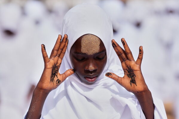A Muslim girl performs Eid al-Adha prayers in the Yoff neighborhood of Dakar, Senegal, Thursday, May 28, 2026. (AP Photo/Misper Apawu)